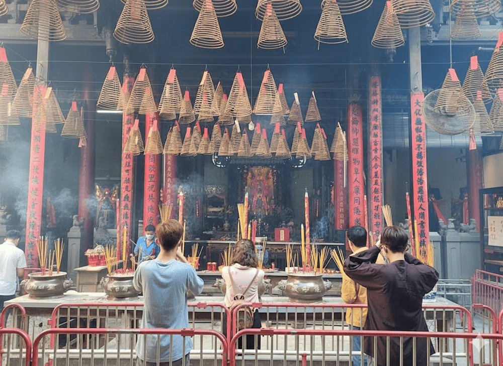 Locals lighting spiral incense and quietly praying in the Temple’s peaceful sanctity